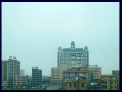 Skyline with abandoned postmodern highrise construction, Dongguan.